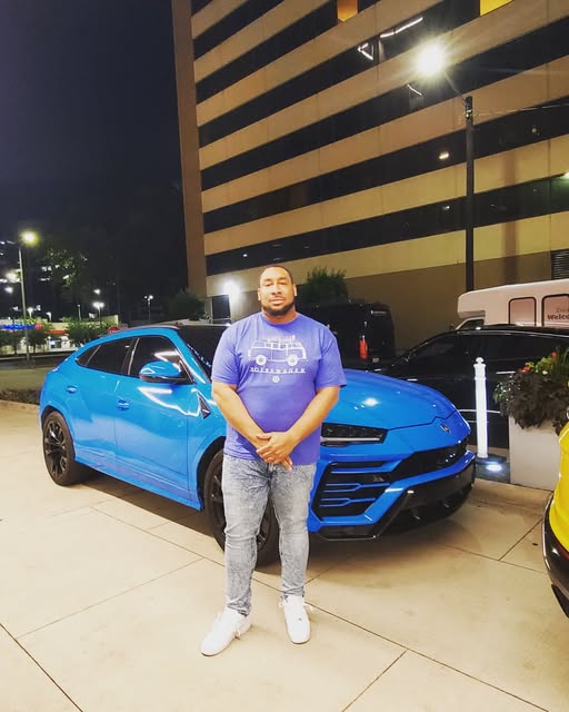 Jeremy Graham standing next to a car at night